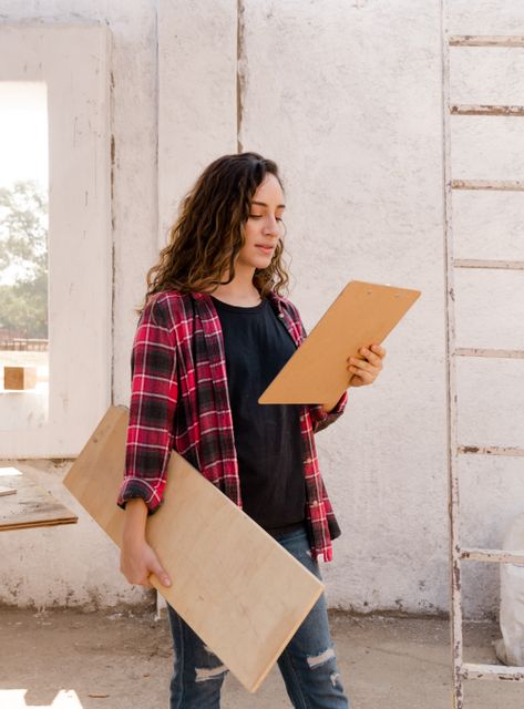 A carpenter reviewing plans at a job site