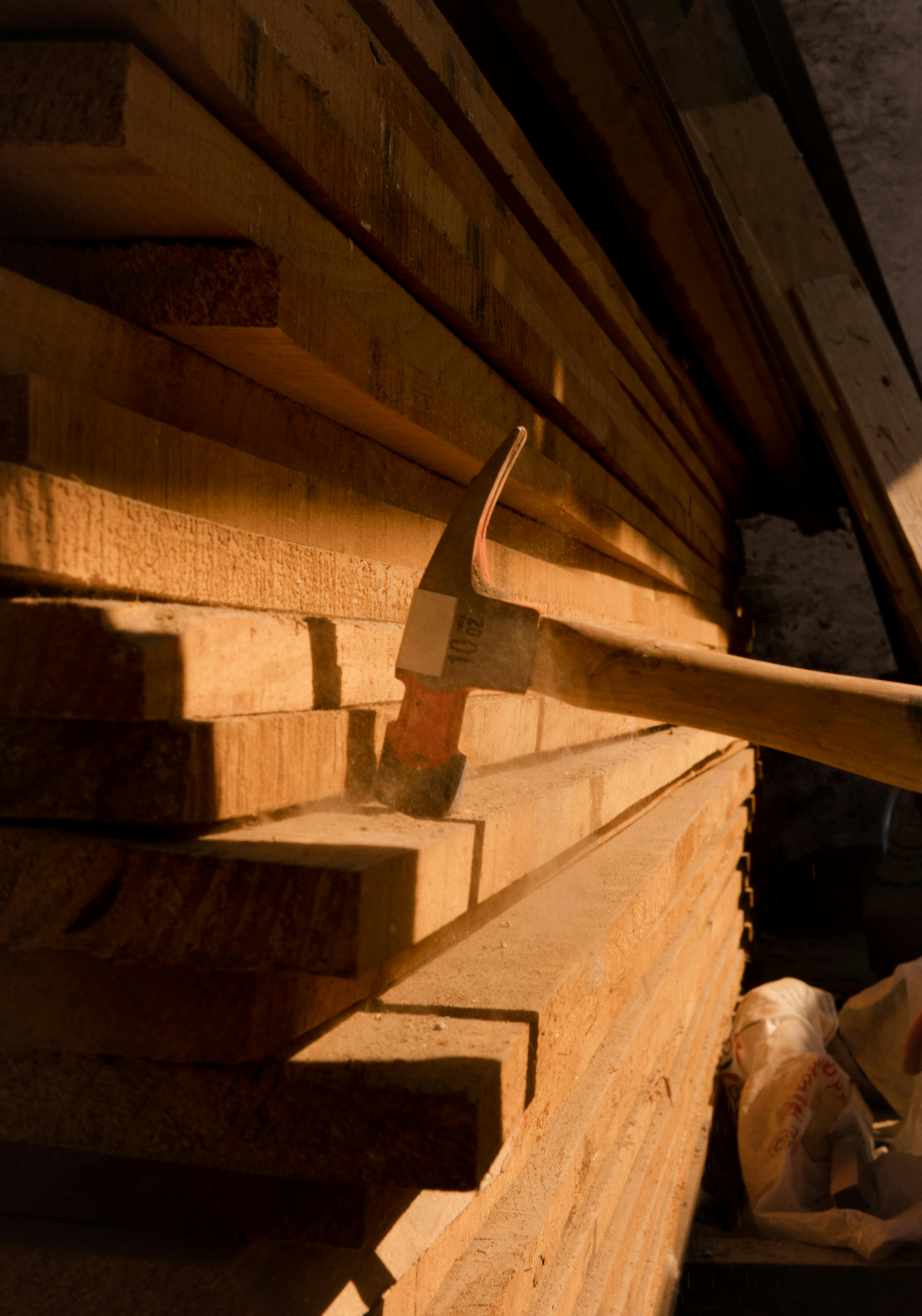 Hammer on a Pile of Lumber · Free Stock Photo