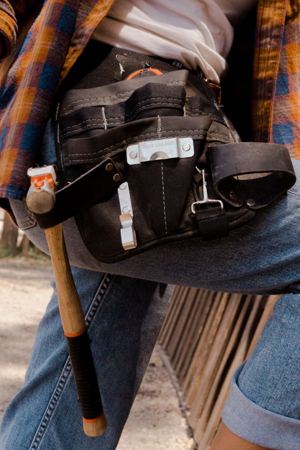Close-up of a tool belt worn outdoors