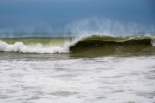 Vivid photograph of an ocean wave crashing, showcasing nature's power and beauty.