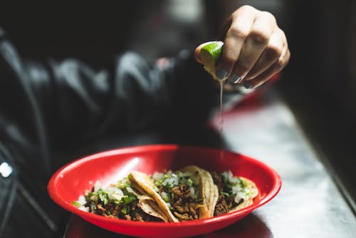 Free Person Squeezing Lime on the Tacos Stock Photo