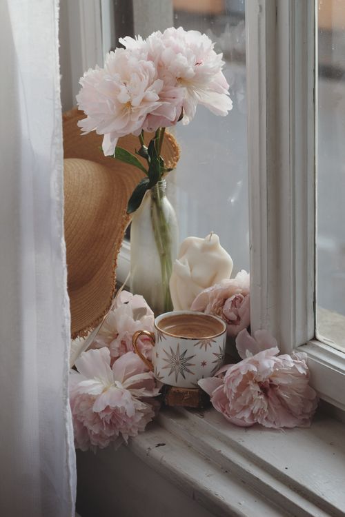 Free A warm and inviting still life featuring peonies and coffee on a windowsill. Stock Photo