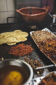 Vibrant Mexican ingredients being prepared for tacos on a griddle.