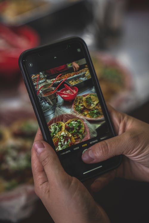 Free Close-Up View of a Person Taking Photos of Delicious Food Stock Photo