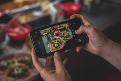 Display Screen of a Smartphone Taking Photo of Food
