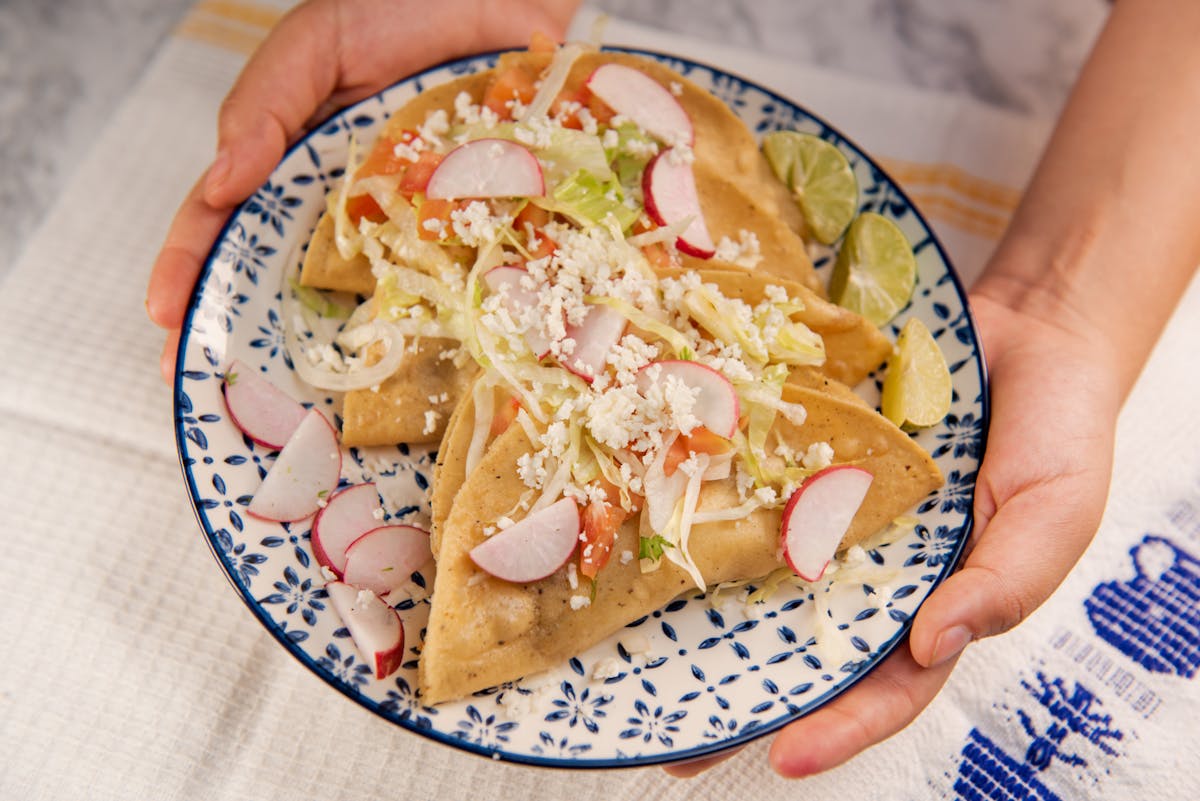 Cook chopping fresh vegetables on a cutting board
