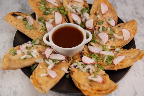 Free Close-up of Mexican street tacos with salsa, garnished with radish and cilantro on a marble background. Stock Photo