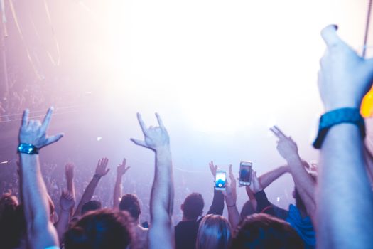A lively nightclub scene with a vibrant crowd enjoying music and lights.