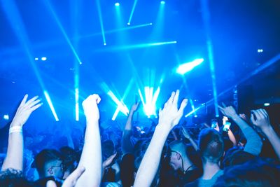 Nightclub crowd under colourful stage lights