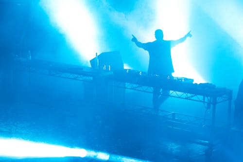 Silhouette of a DJ Playing Music at the Nightclub