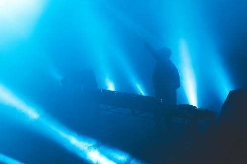 Silhouette of a DJ Playing Music at the Nightclub
