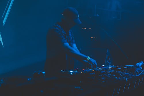 A DJ Playing Music at the Nightclub