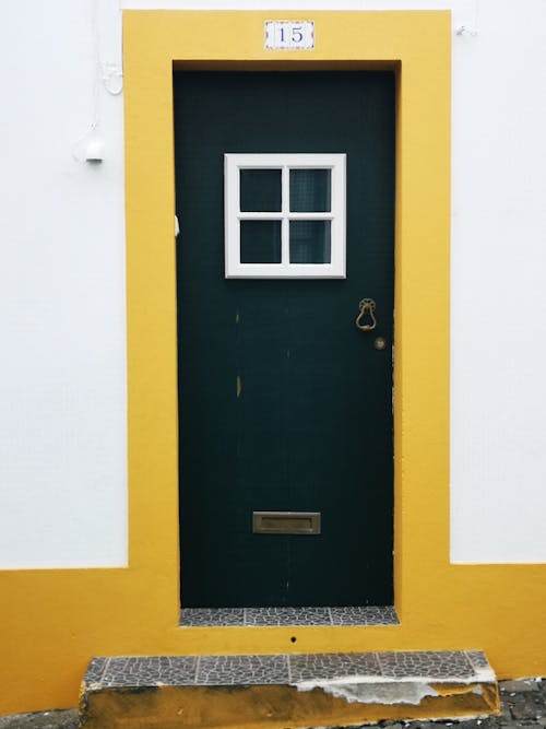 Black Door on Yellow and White Concrete Wall