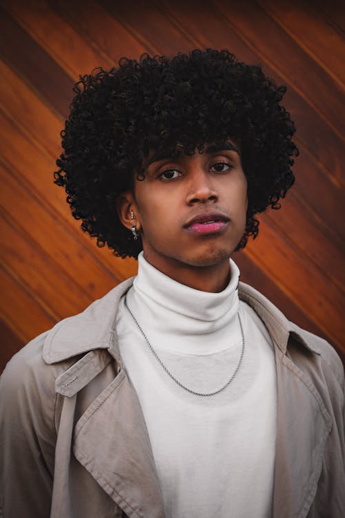 Curly Haired Man in White Turtleneck Shirt and Beige Trench Coat 