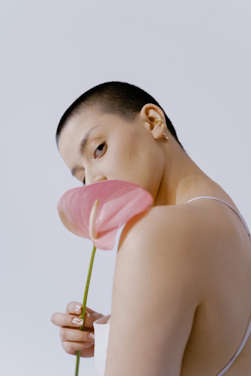 Free Woman Holding a Pink Flower Stock Photo