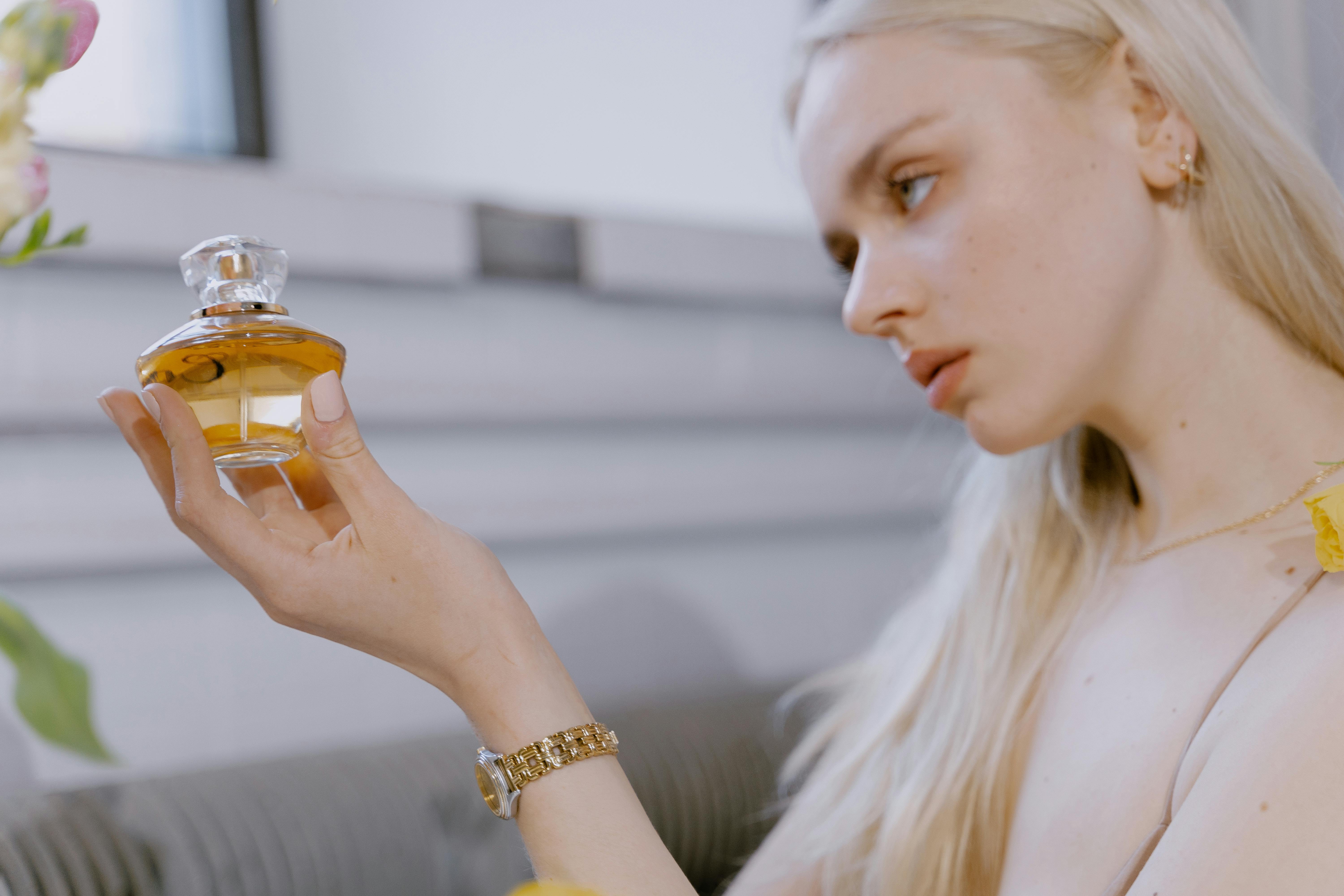 woman holding a perfume