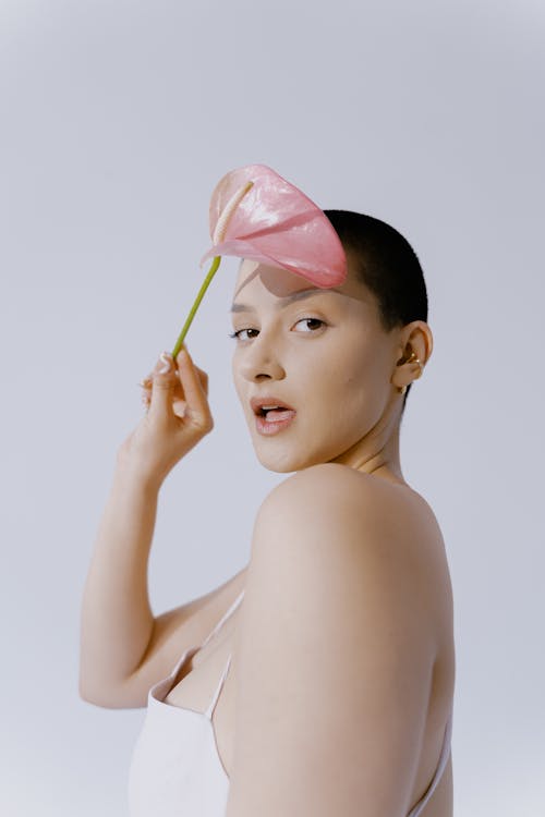 Free Woman Holding a Pink Anthurium Stock Photo