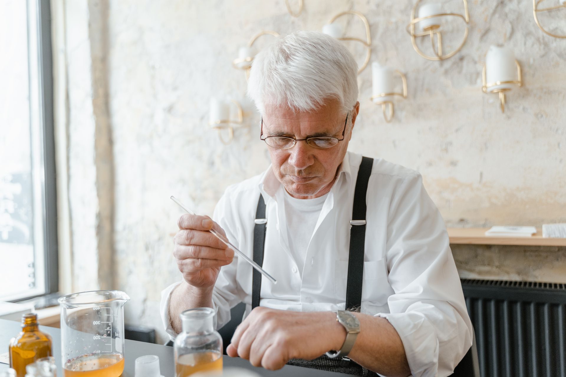 Elderly Man Testing Liquid on Hand