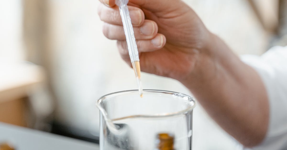 A Person Holding a Dropper · Free Stock Photo