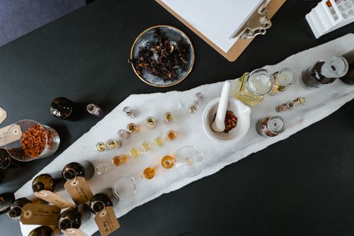 Free Overhead view of an aromatherapy setup with glass bottles and ingredients on a table. Stock Photo