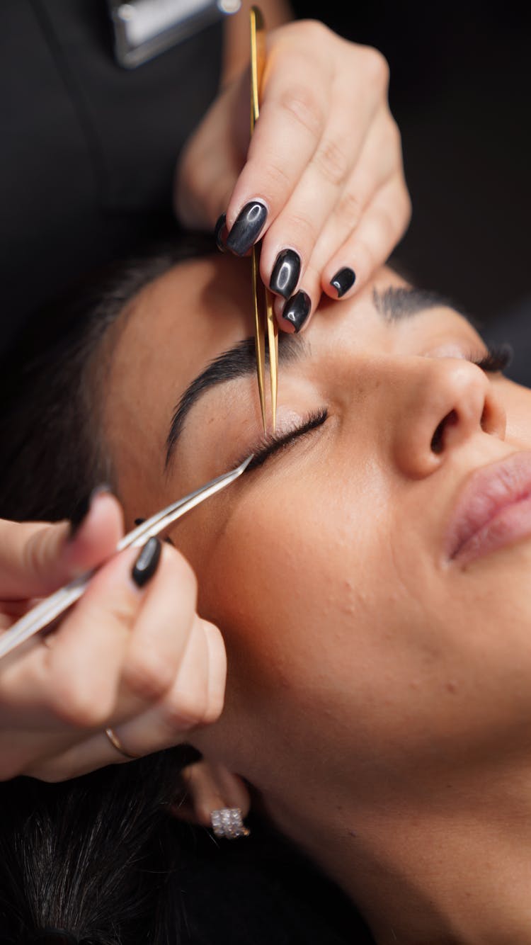 A Person Putting Eyelash Extension On The Client