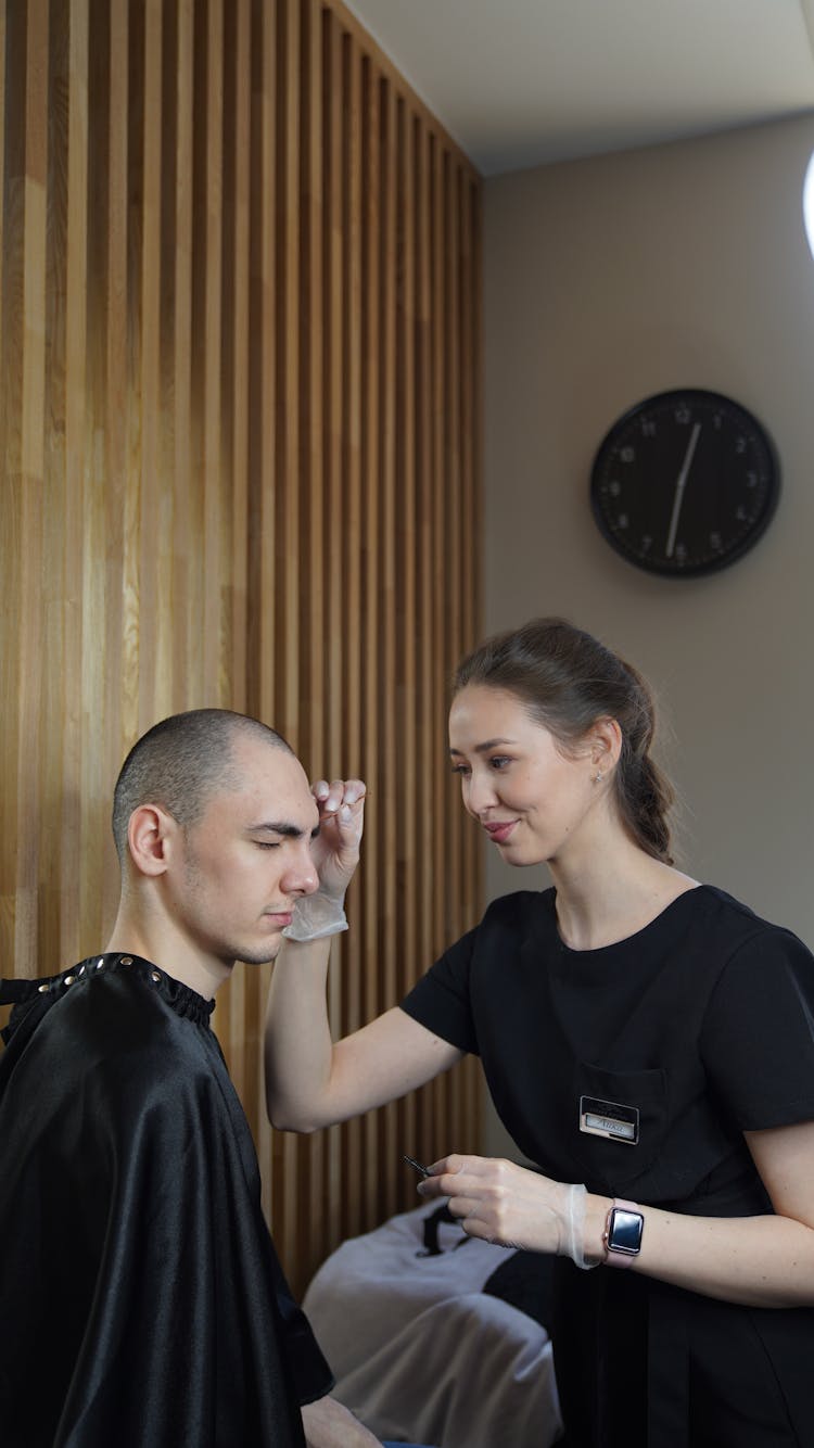 Woman Shaping Mans Eyebrow