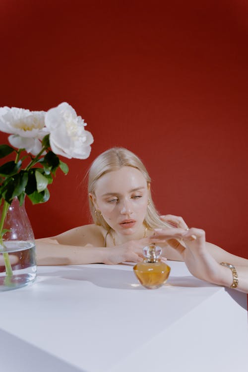 Woman Looking at a Bottle of Perfume