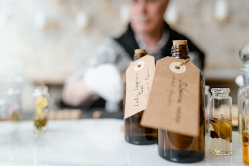 Brown Glass Bottles with Tags on White Table