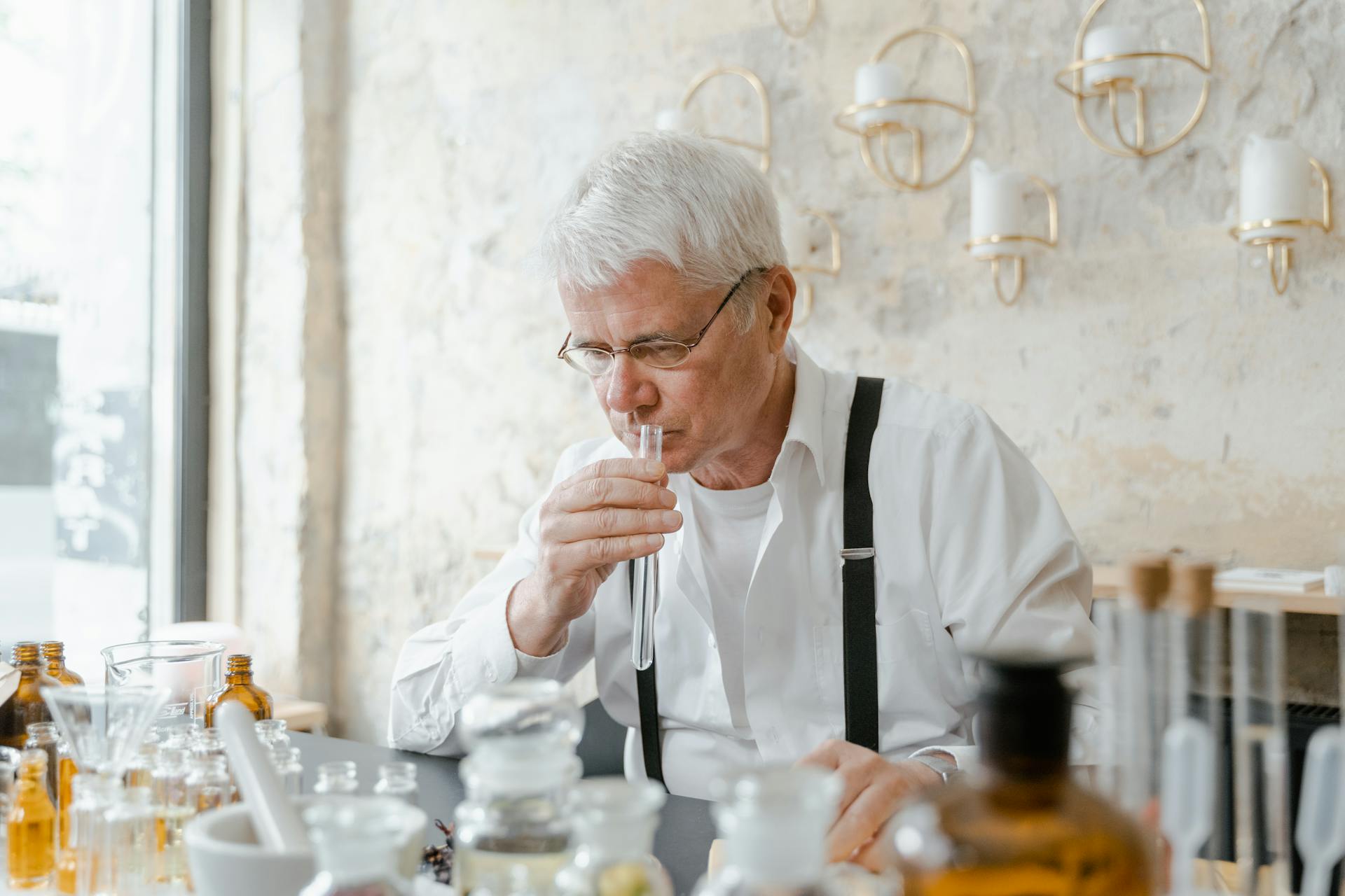 Elderly Man Smelling Liquid in a Test Tube