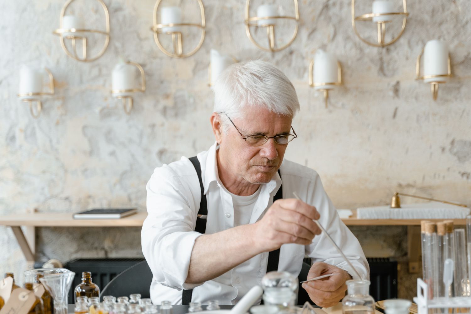 Craftsperson carefully measuring ingredients with laboratory glassware
