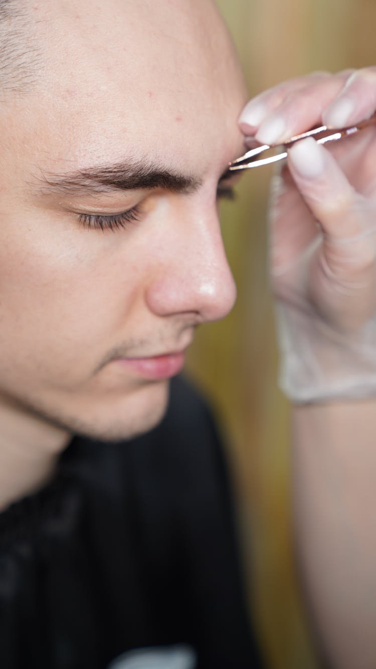 Man Having His Eyebrows Plucked