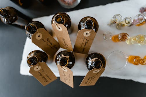 Brown Bottles with Tags on a White Surface