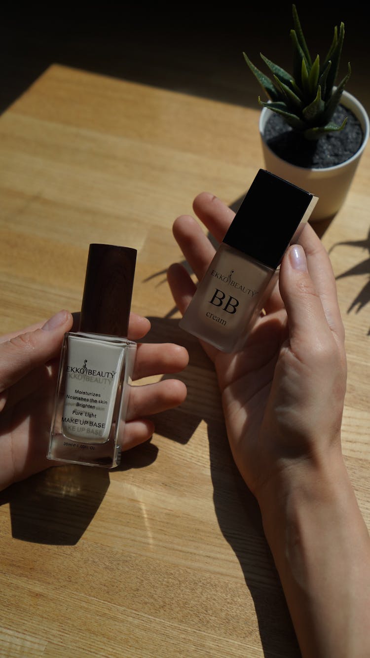 Woman Holding Face Makeup Products In Hands