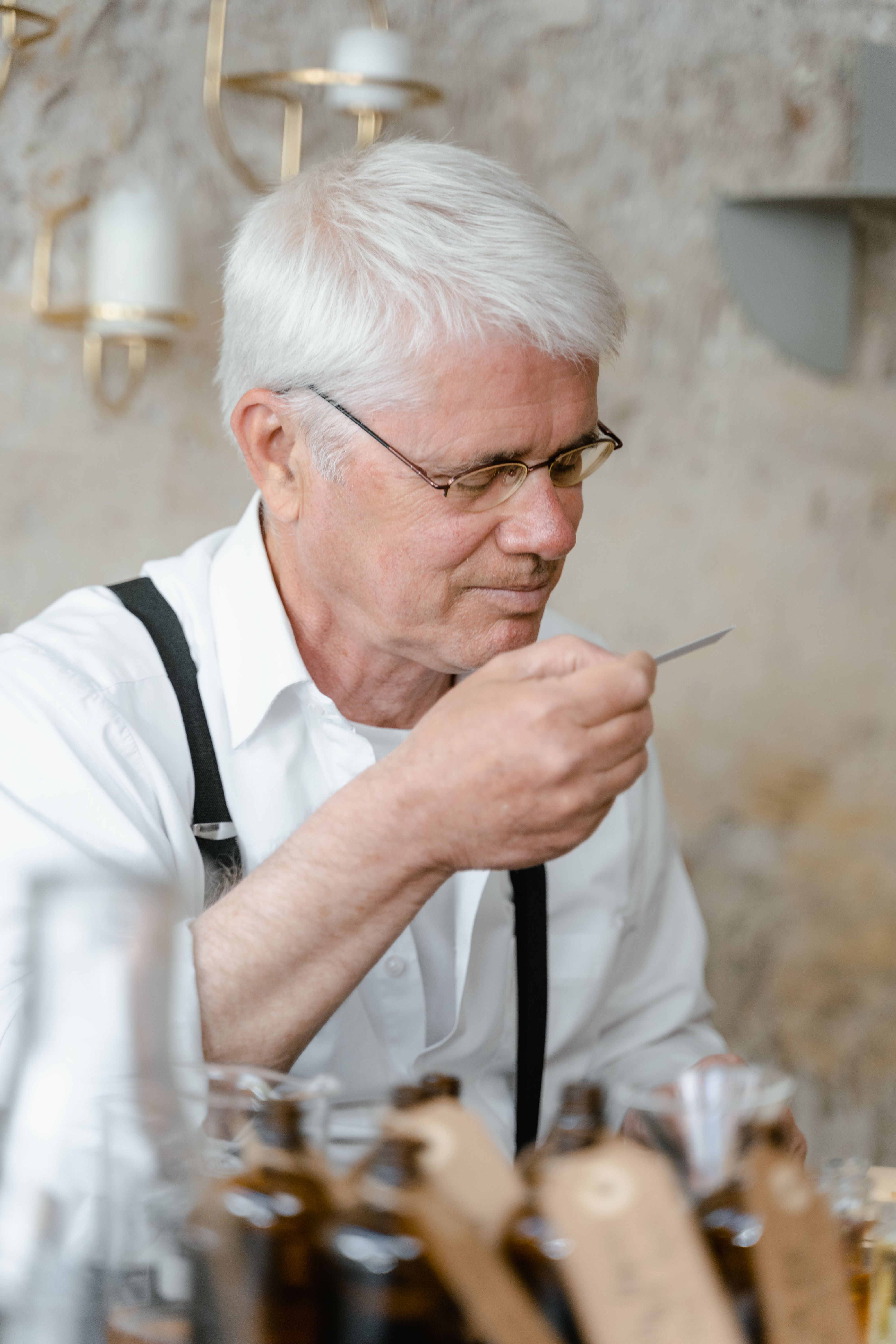 A perfumer testing a blotter strip at a workbench — MART PRODUCTION on Pexels