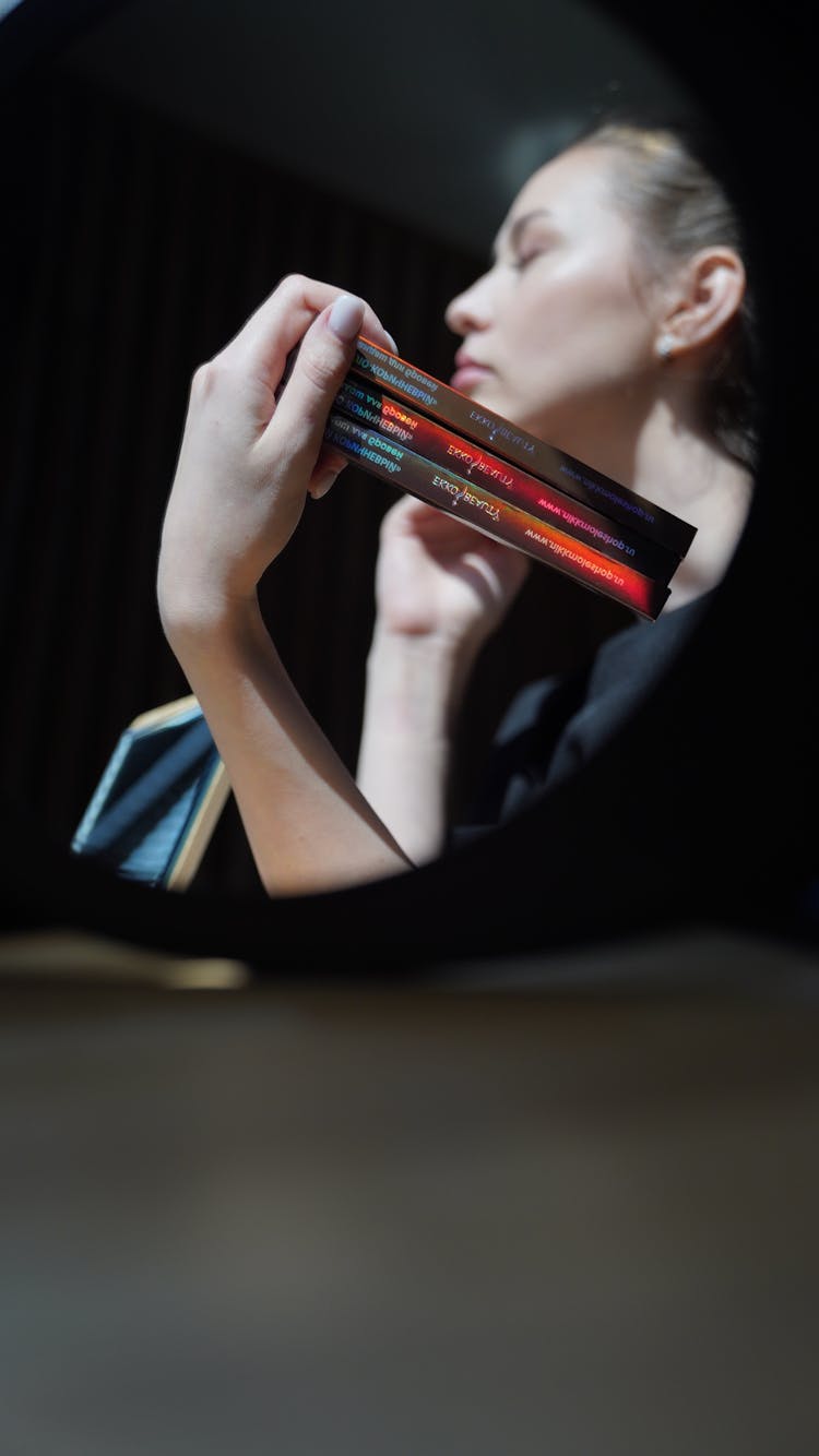 Woman In Mirror Showing Beauty Products