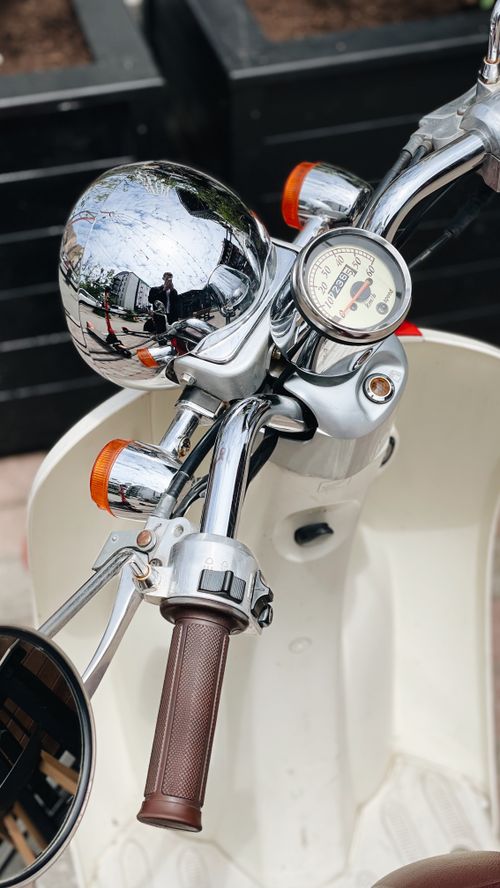 Free Discover the vintage charm of a classic chrome moped in Vladivostok. Ideal for retro enthusiasts. Stock Photo