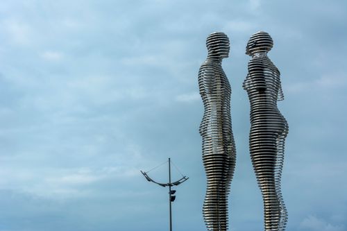 Free Artistic photo of dynamic moving statues with a sky backdrop, capturing modern sculpture elegance. Stock Photo