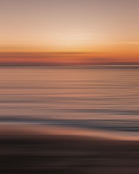 Capture the serene beauty of a Hawaiian sunset over the ocean with vivid colors and calming waves.