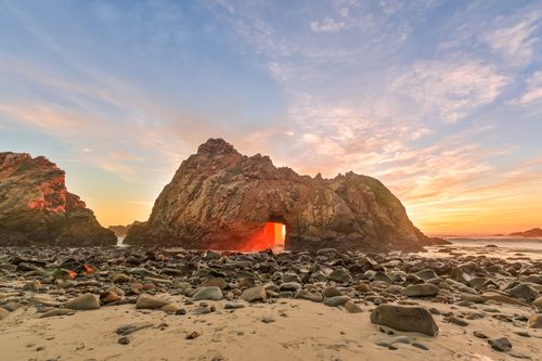 Free Sunset view of Pfeiffer Beach rock arch with vibrant colors in California. Stock Photo