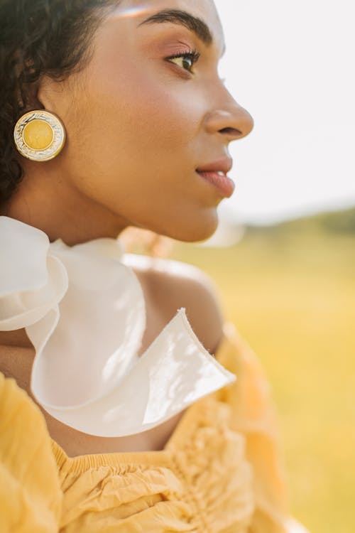 Free Pretty Woman Wearing a Scarf Looking Afar Stock Photo