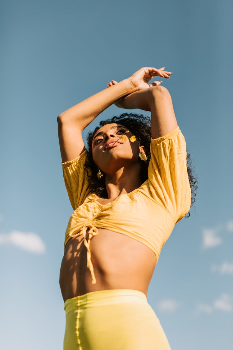 Woman In Yellow Crop Top Raising Her Hands