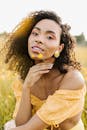 Woman in Off Shoulder Crop Top Holding Yellow Flower