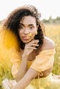 Woman in Yellow Sleeveless Dress Holding Yellow Flower