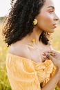 Woman in Yellow Spaghetti Strap Top Holding Her Hair