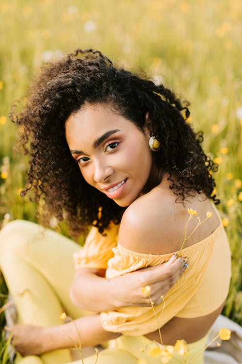 Woman in Yellow Dress Lying on Green Grass Field