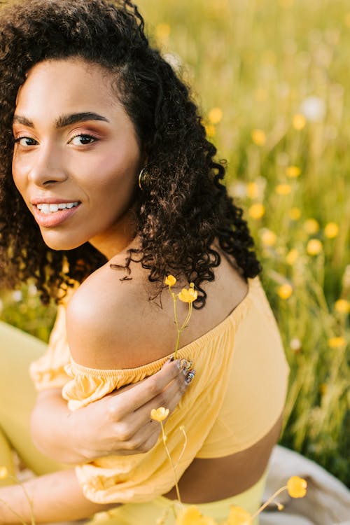 Woman in Yellow Crop Top Looking Over Her Shoulder