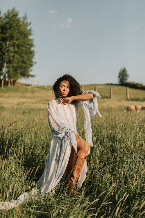 Free Woman in White Dress Standing on Grass Field Stock Photo