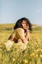 Woman Sitting on Yellow Flower Field