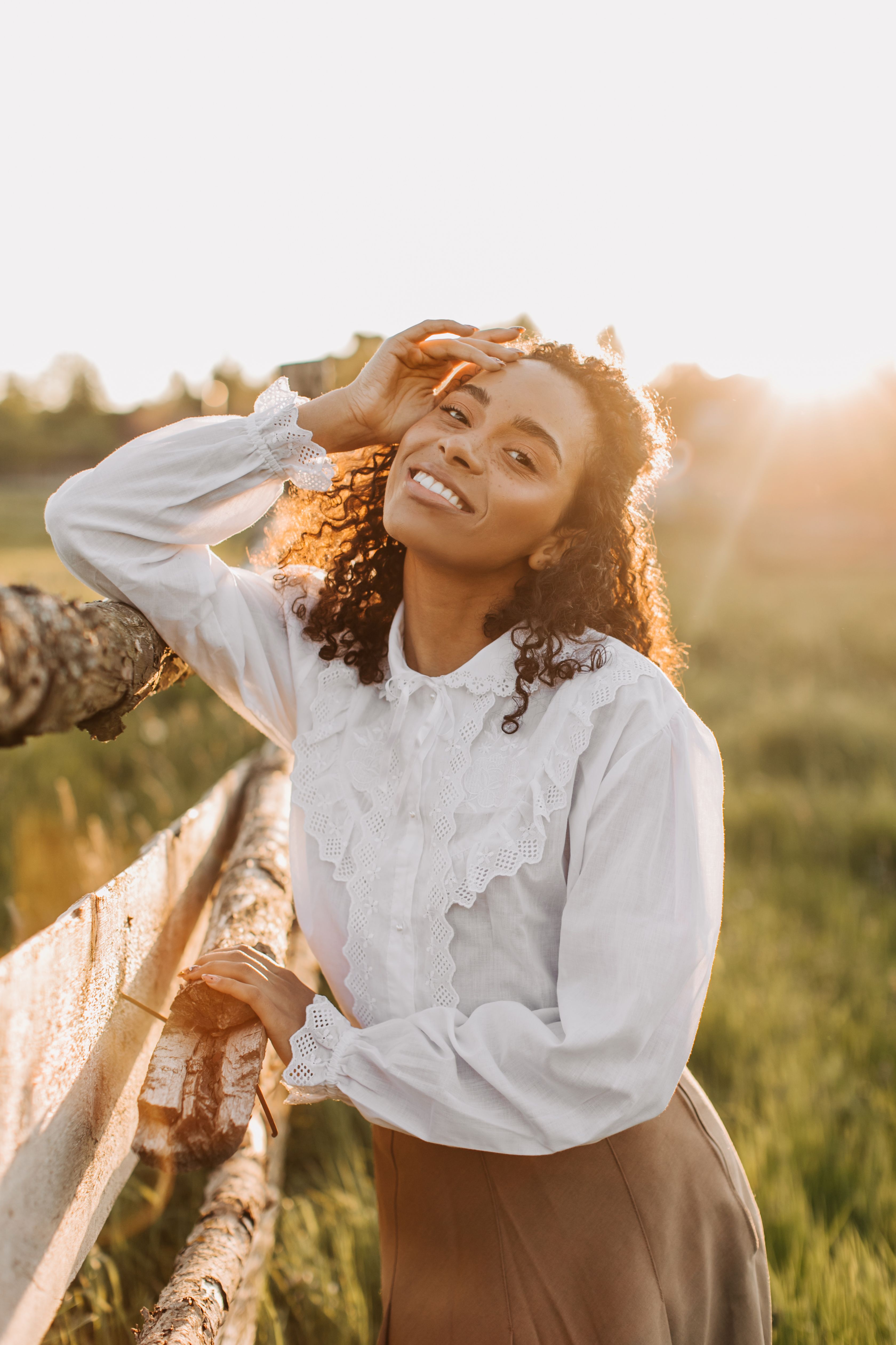 Woman in White Long Sleeve Shirt Standing on Green Grass Field · Free ...