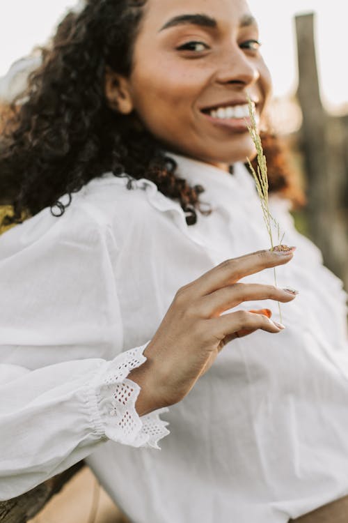 A Woman in White Long Sleeves Smiling